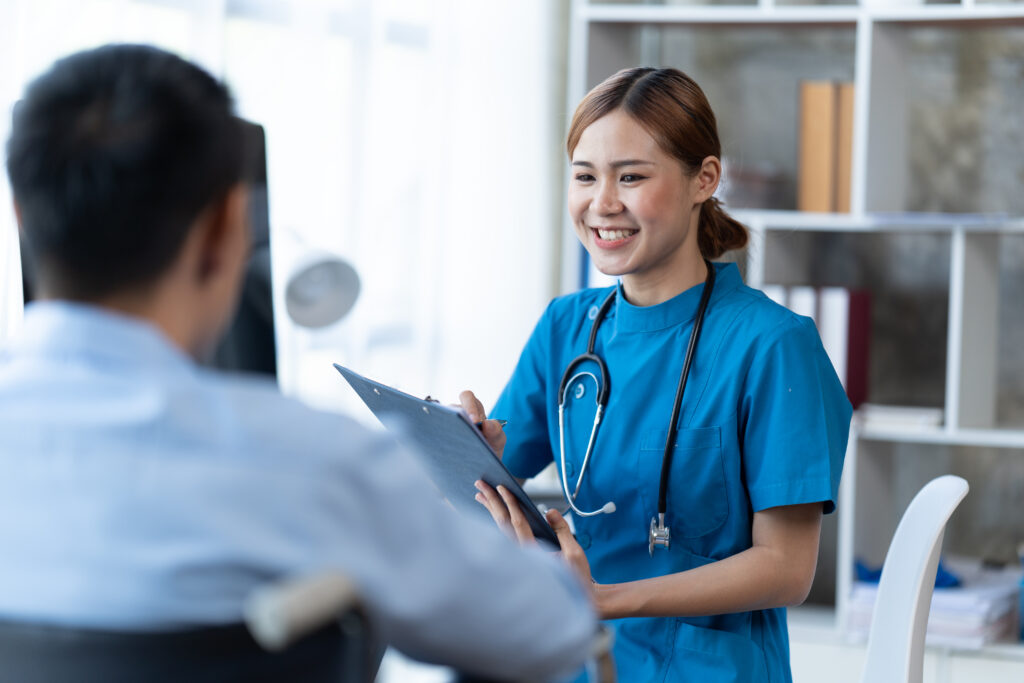 Doctor and patient sitting and talking at medical examination at