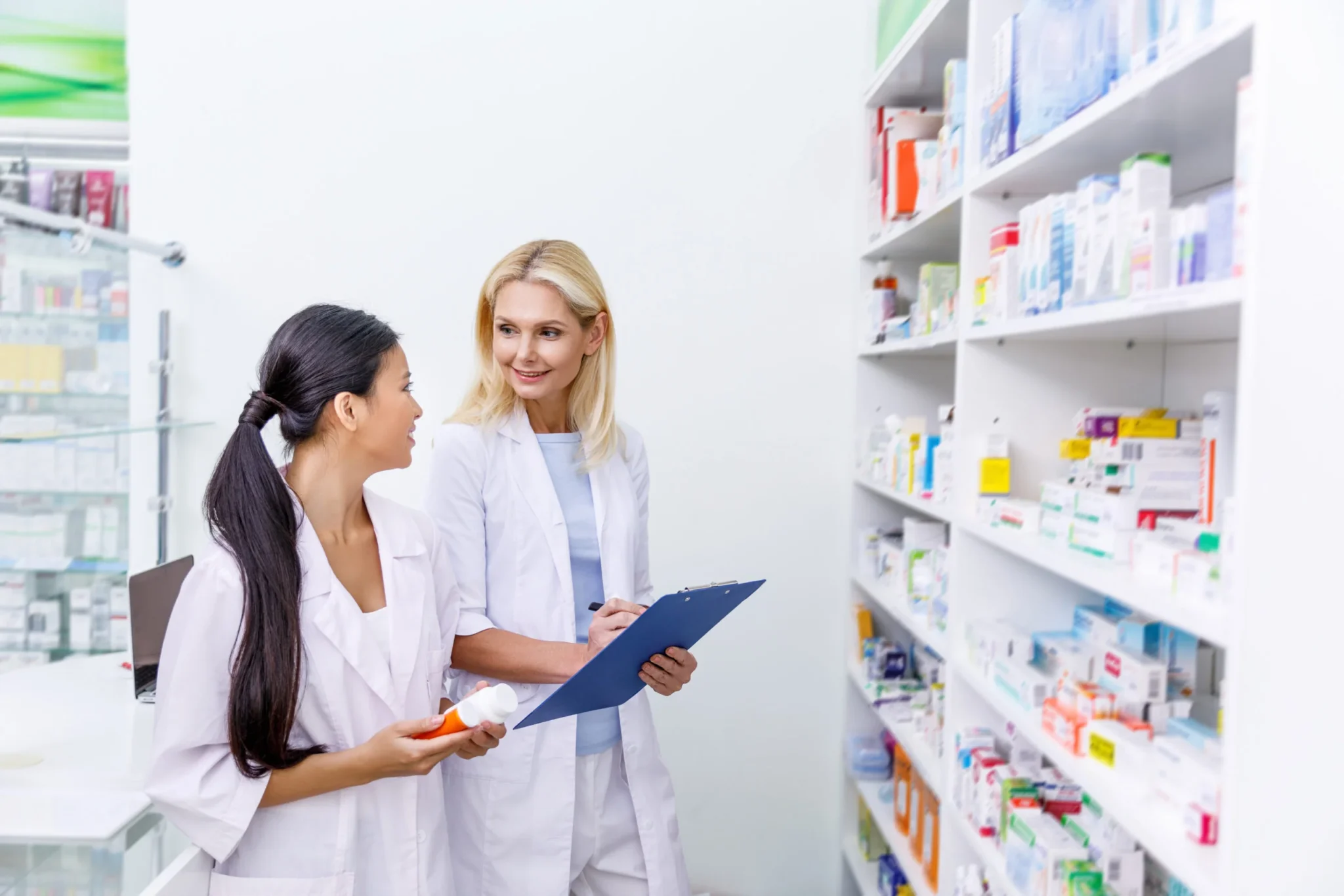 female-pharmacists-with-medication-and-clipboard
